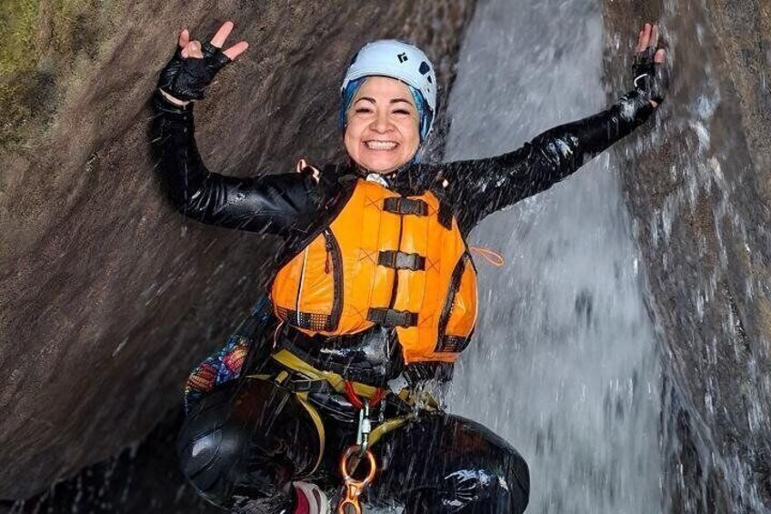 A person rappelling down a waterfall. 3