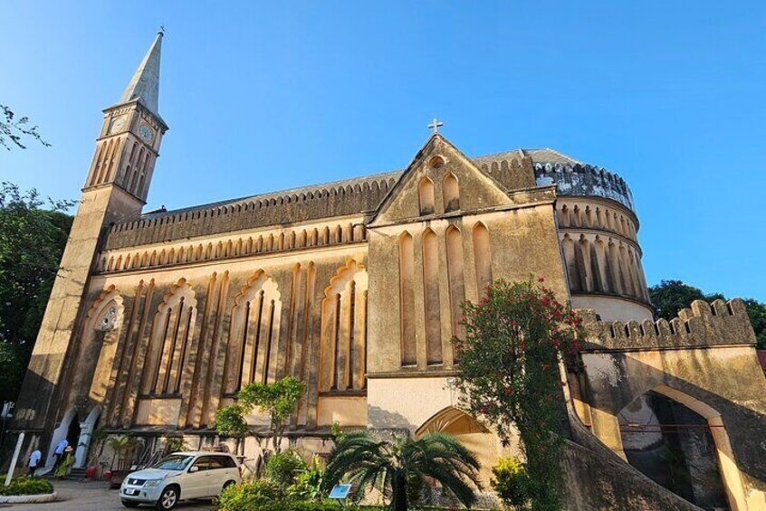 A historic church with a prominent tower and arched windows. 2