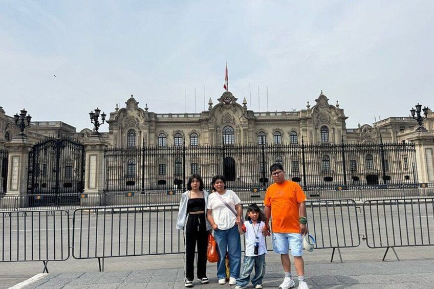 A family of four in front of a grand historic building with ornate architecture. 2