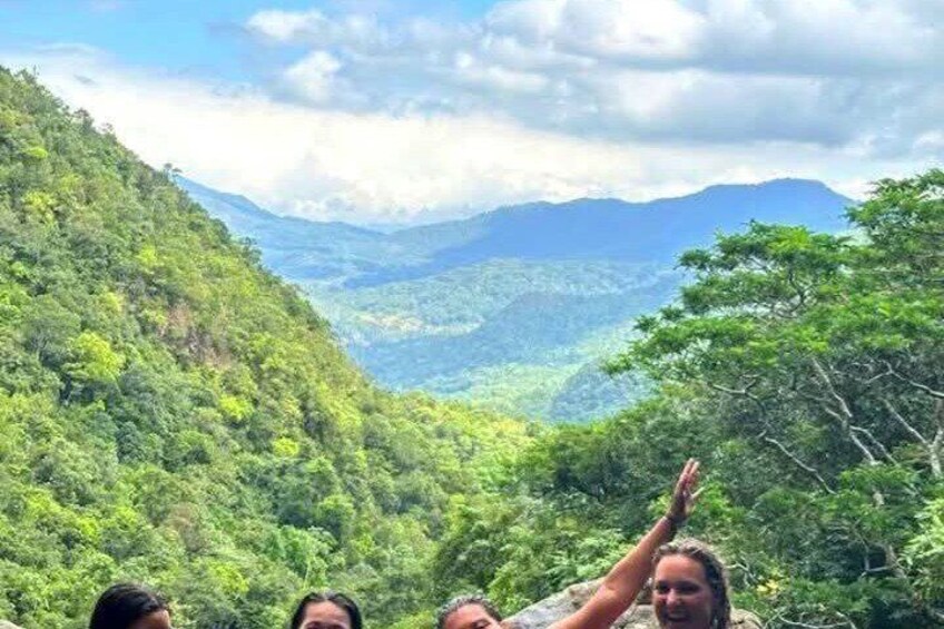 A mountainous landscape with dense green foliage and a clear sky. 4
