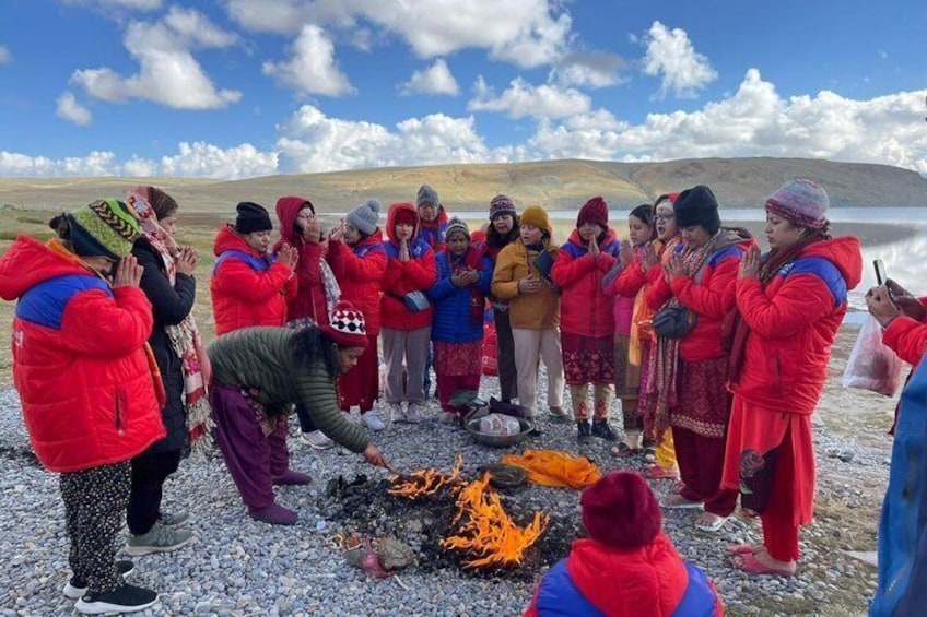 A group of people around a campfire in a mountainous area. 4