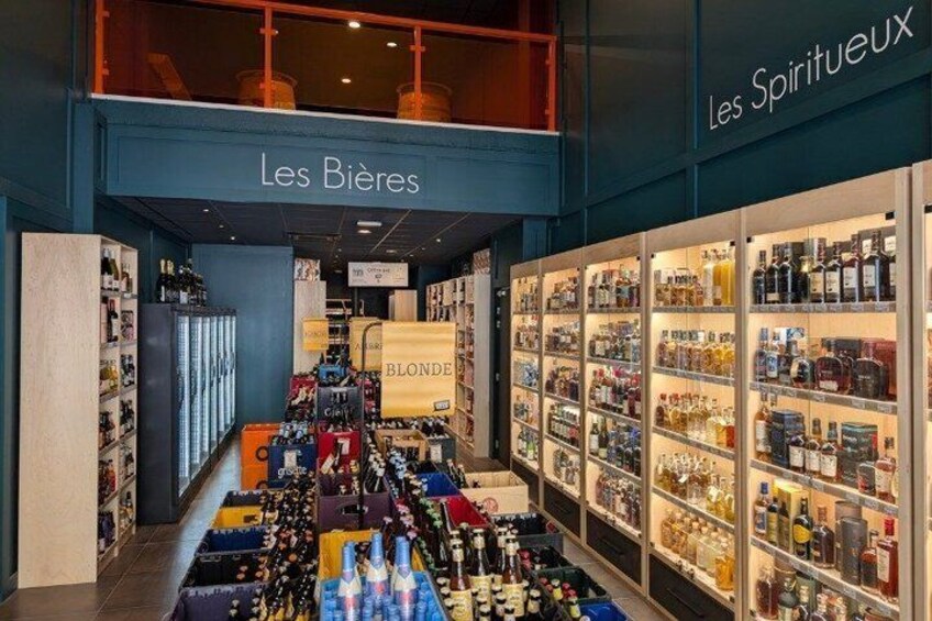 A liquor store with shelves of bottles and a sign reading 'Les Bières.' 1