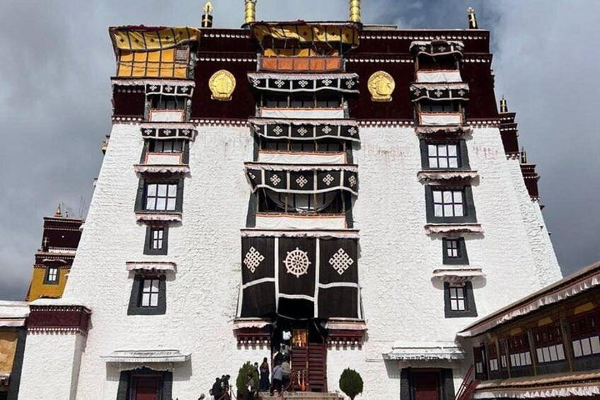 A traditional building with ornate decorations and multiple windows. 4