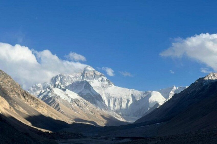 A mountain range with snow-capped peaks under a clear blue sky. 3