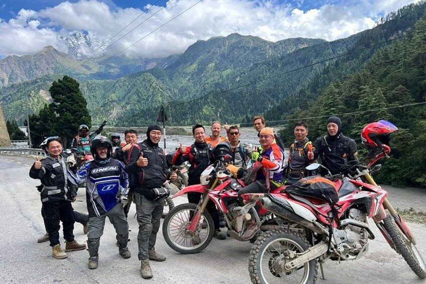 A group of people with motorcycles in a mountainous area. 1