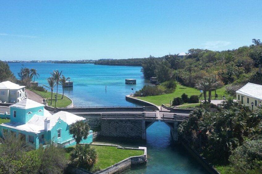 A turquoise house, a bridge, and a calm blue sea. 2