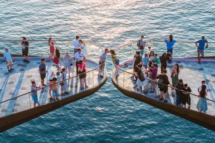 A circular water structure with people standing on it. 4