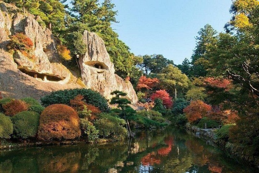 A serene river with rocky cliffs and autumn-colored trees. 3
