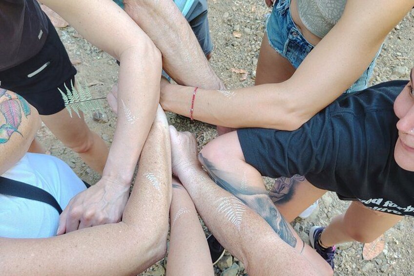A group of people with their arms around each other, forming a circle. 3