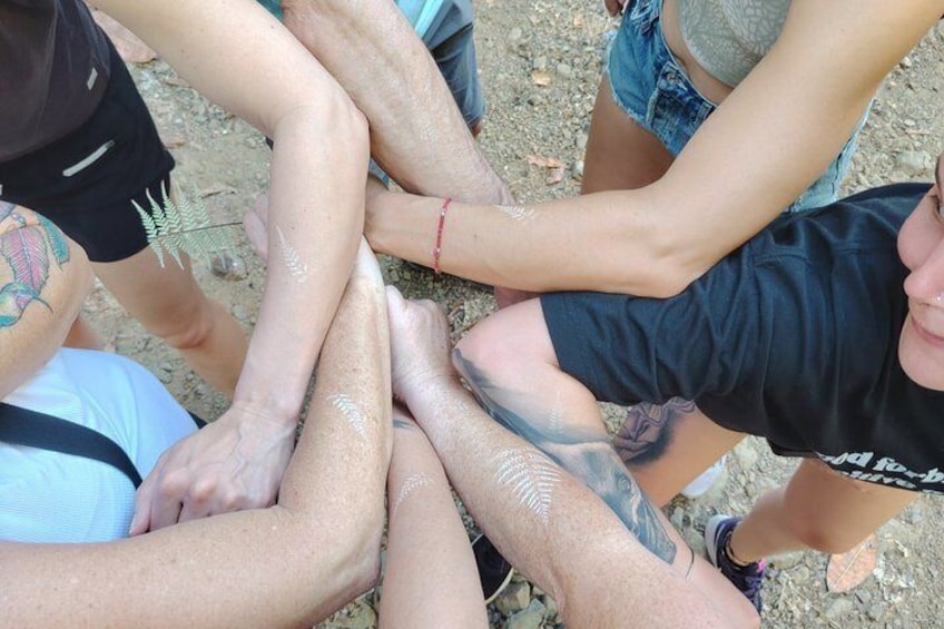 A group of people with their arms around each other, forming a circle. 3