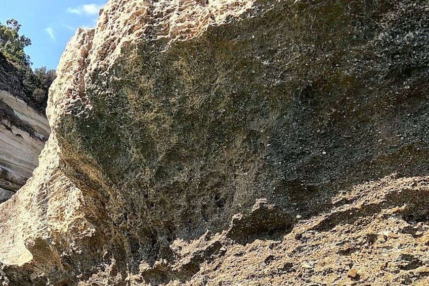 A large rock formation with a steep cliff face. 5