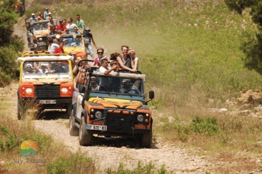 A convoy of off-road vehicles on a dirt path. 3