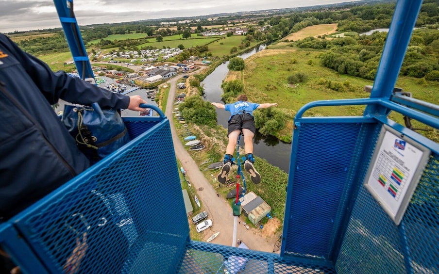A bungee jump platform overlooking a river and village. 2