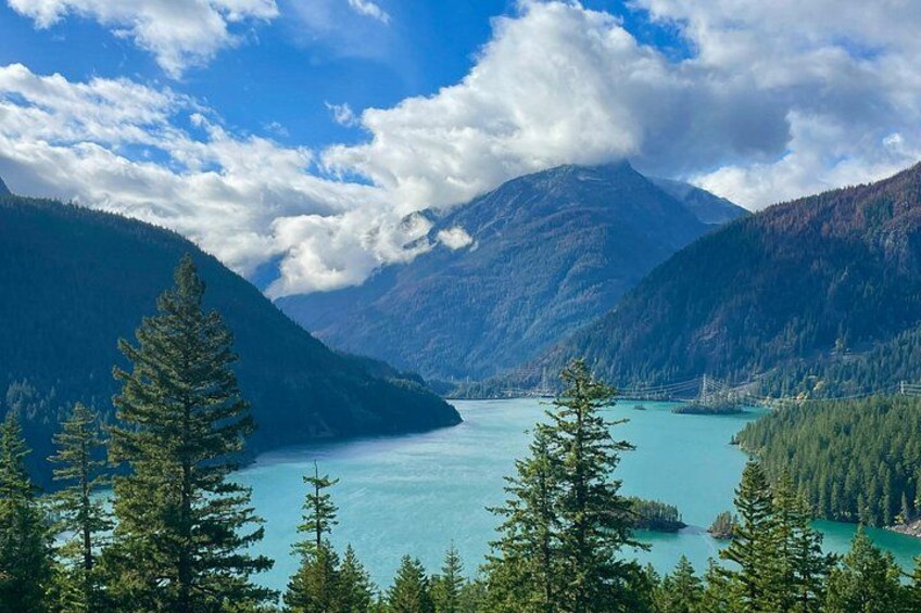 A mountain lake surrounded by forested mountains. 3
