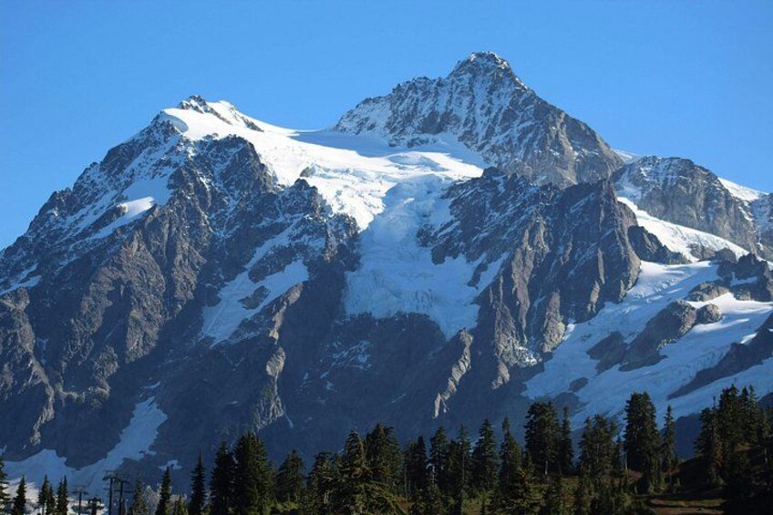 A snow-capped mountain range with clear skies. 1