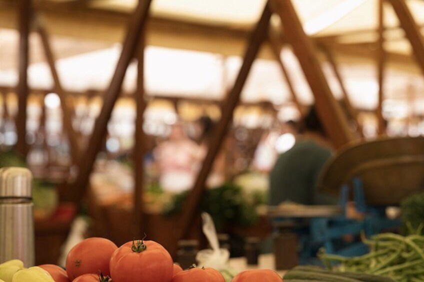 A market stall with tomatoes and other vegetables. 3