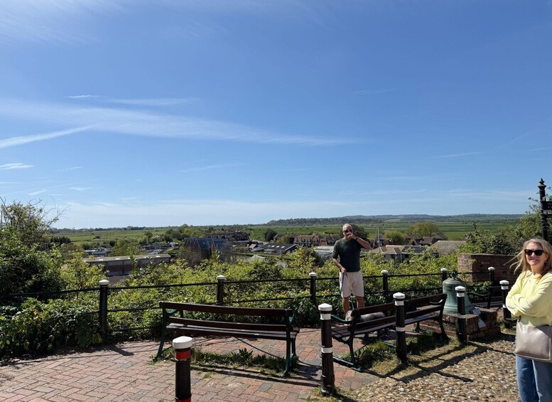A park with benches overlooking a village. 5
