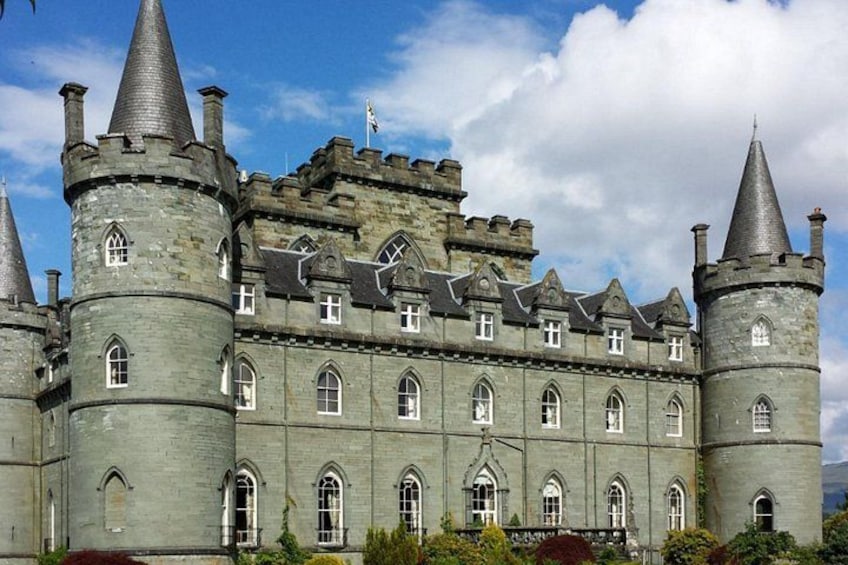 A large, historic castle with multiple towers and arched windows. 4