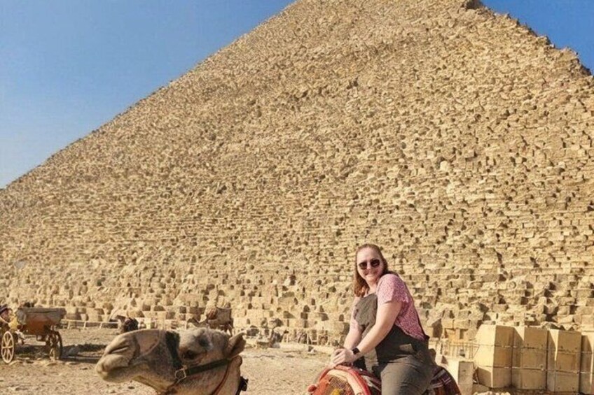 A pyramid with a person sitting in front of it. 3