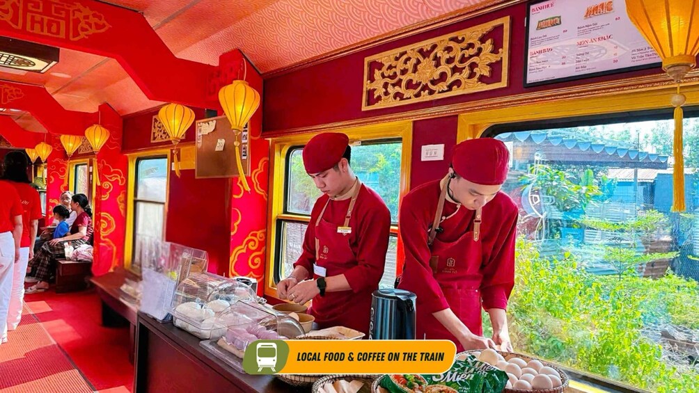 A train dining car with red decor and staff serving food. 4