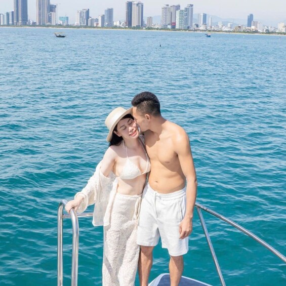 A couple on a boat with a city skyline in the background. 3