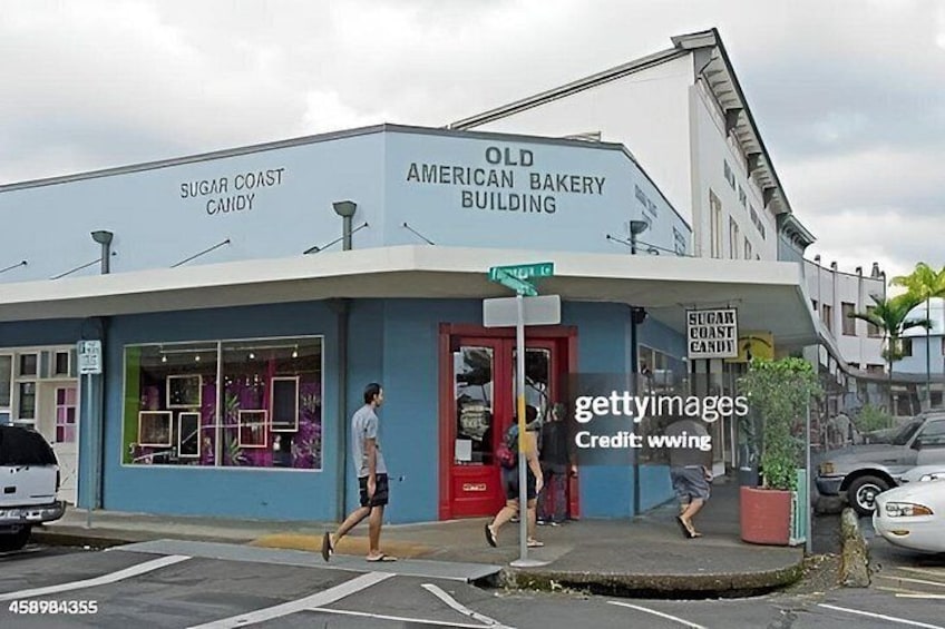 A building with signage for 'Old American Bakery Building' and 'Sugar Coast Candy.' 3