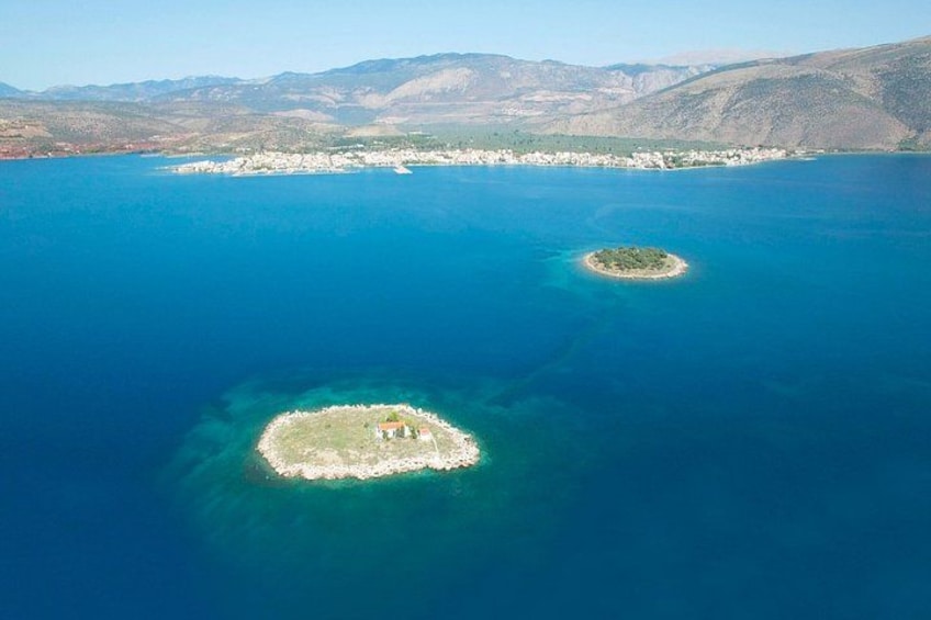An aerial view of a coastal area with two small islands surrounded by clear blue waters. 4