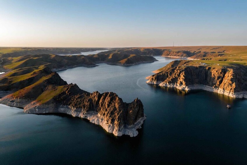 A coastal landscape with rocky outcrops and calm waters. 3