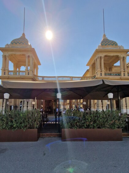 A building with two domed structures and a covered entrance area. 3