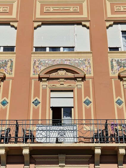 A building with ornate architectural details, including a decorative archway and patterned windows. 4