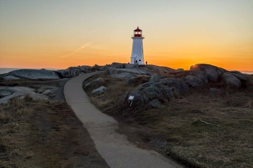 A lighthouse on a rocky outcrop with a winding path leading to it. 1