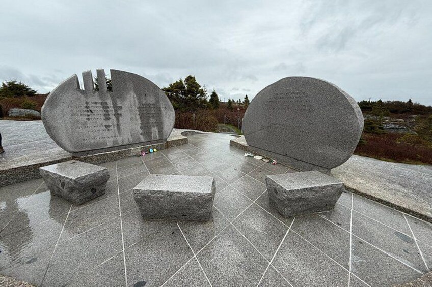 Two large stone monuments with inscriptions, surrounded by stone benches and a tiled ground. 5