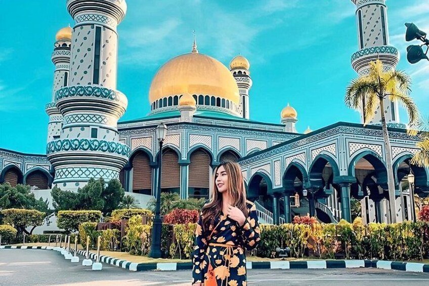 A mosque with a large golden dome and multiple minarets. 2