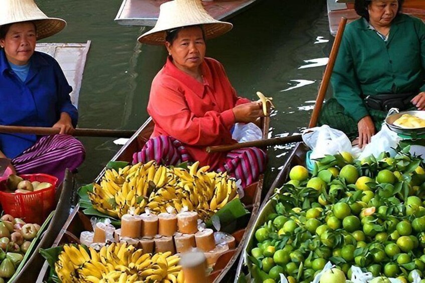 Three women in a boat, selling bananas and limes. 1