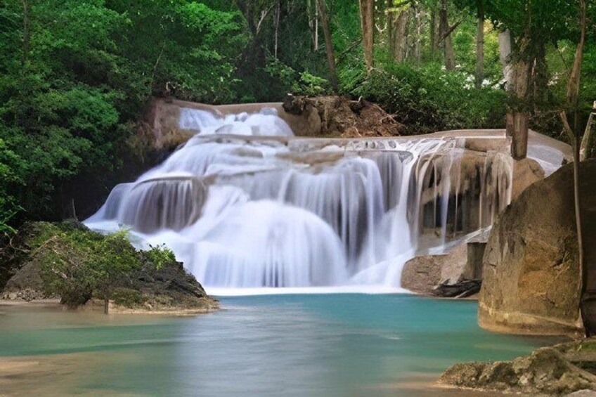 A multi-tiered waterfall surrounded by lush greenery. 5