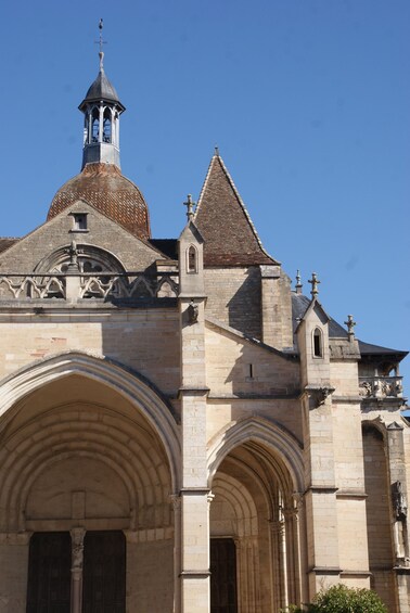A historic church with a prominent bell tower, arched entrance, and intricate stonework. 5