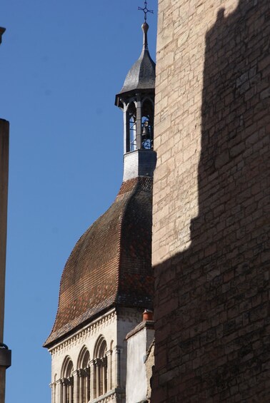 A church tower with a pointed roof and a weather vane. 4