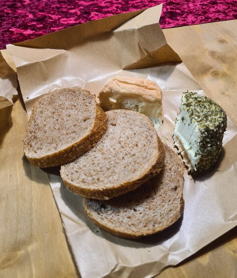 Slices of whole grain bread and a piece of cheese on a brown paper. 3
