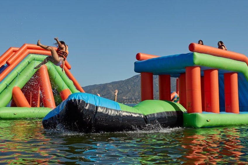 An inflatable water park with slides and a pool. 5