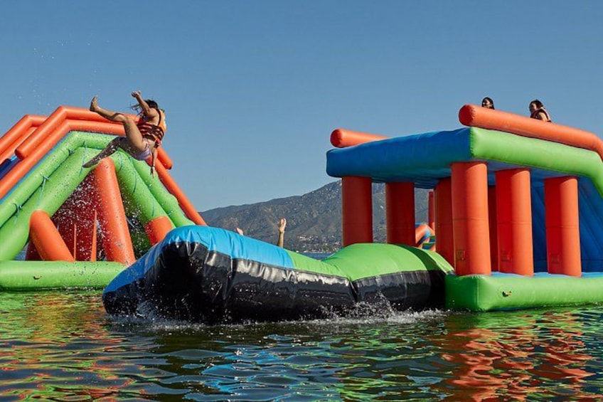 An inflatable water park with slides and a pool. 2