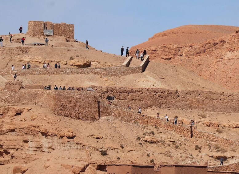 Ancient ruins with people exploring the site. 4
