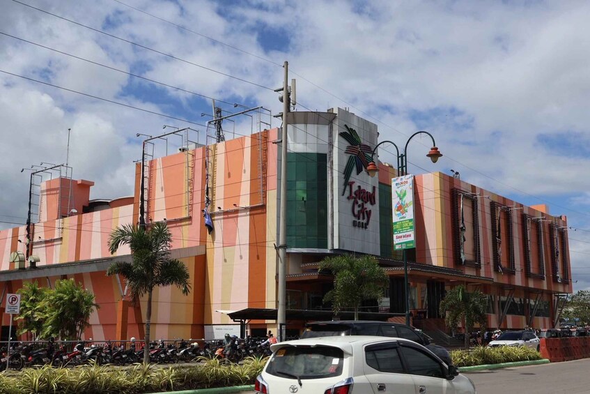 A multi-story building with a prominent sign for 'Jungle City.' 1