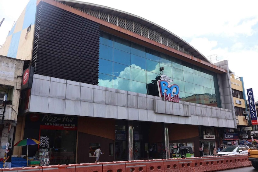 A modern building with a glass facade and a large 'B' logo. 2