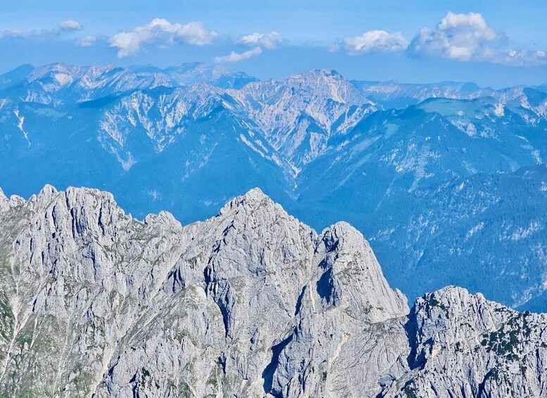 A rugged mountain range with sharp peaks and a clear blue sky. 2