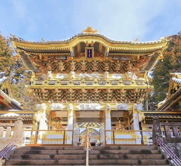 A traditional multi-tiered temple with ornate golden decorations and a central statue. 3