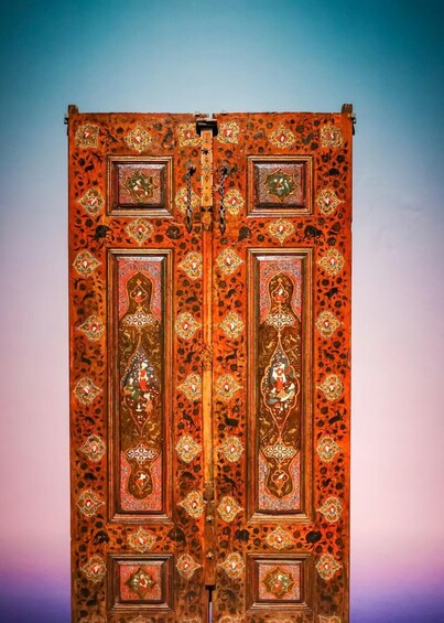 A richly decorated wooden door with intricate patterns and metalwork. 4