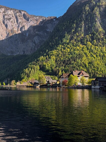 A lake with houses and a mountain in the background. 2