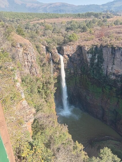 A waterfall cascading down a steep cliff into a river. 3