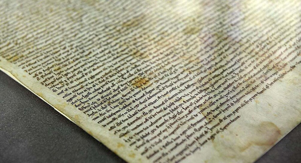 A close-up of an ancient manuscript with visible text and stains. 2