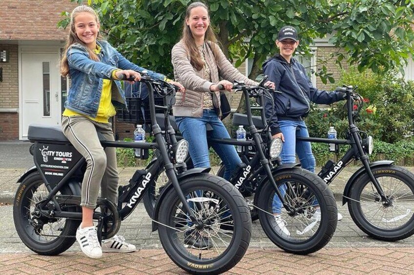 Three people riding electric bikes with 'City Tours' branding. 2